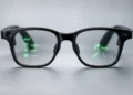 Black AI glasses with green in-lens displays showing navigation directions, messages, and information icons.